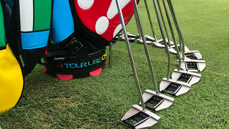 Futura Tour putters around our staff bag on the practice green.