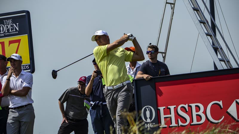 Spieth drives the 17 as Thomas looks on.