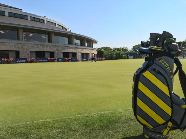 Our Caution Stripe staff bag on the practice green.