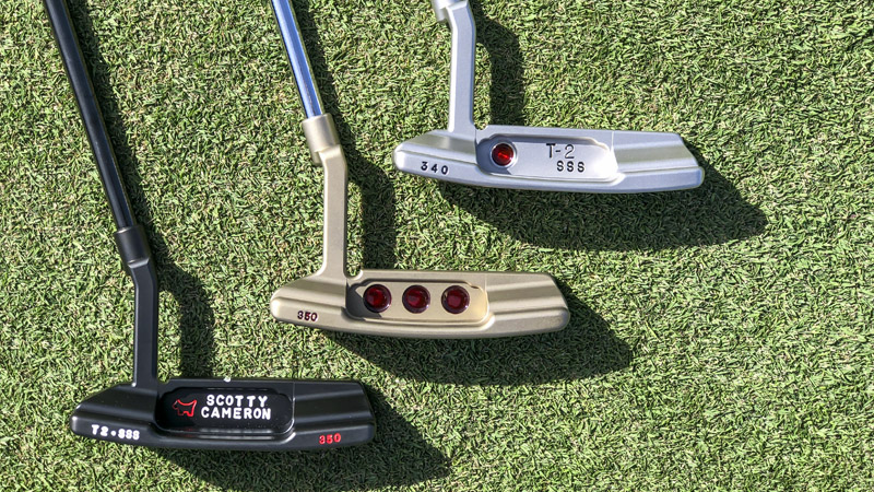 Two Timeless 2 SSS putters surrounding a Newport 2 Timeless SSS in Chromatic Bronze.