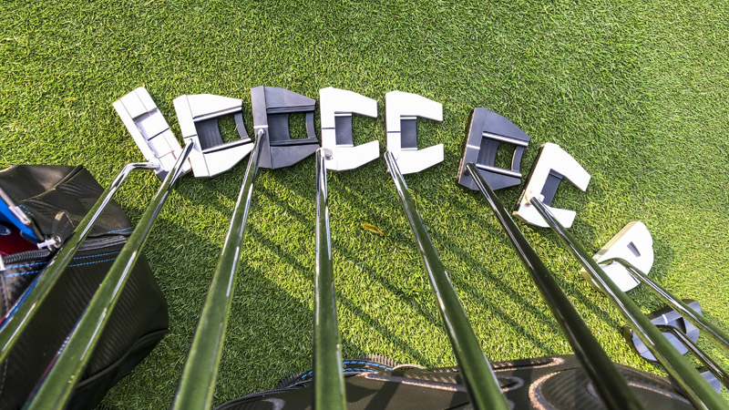 Tour putters on the practice green.