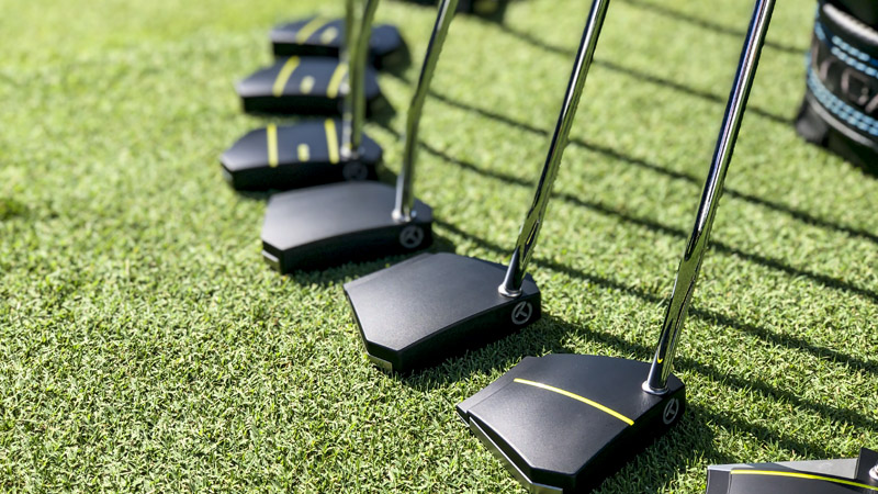 Various Phantom X Tour heads lined up on the practice green.