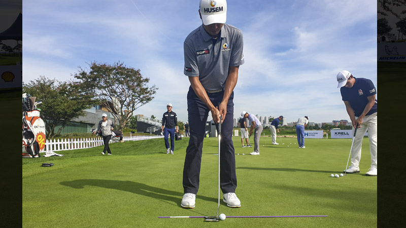 Moon, K.J. on the practice green.