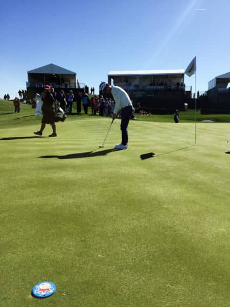 Kevin Na getting some work done, putting to his Jackpot Johnny practice disc.