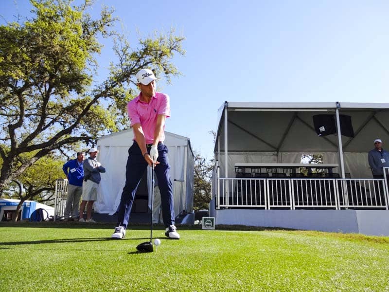 Justin addressing his Titleist golf ball.