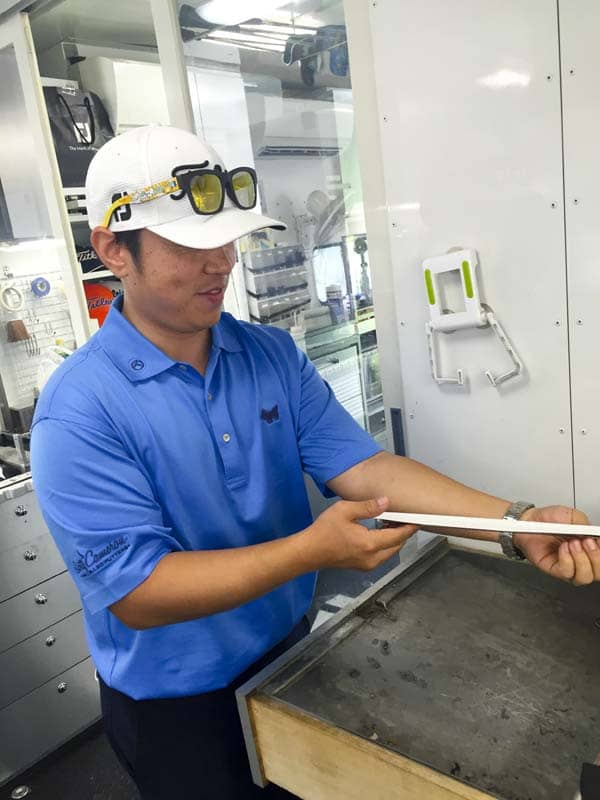 Scotty Cameron Korean Tour rep, Eric Kong re-gripping a putter in the Titleist tour van.