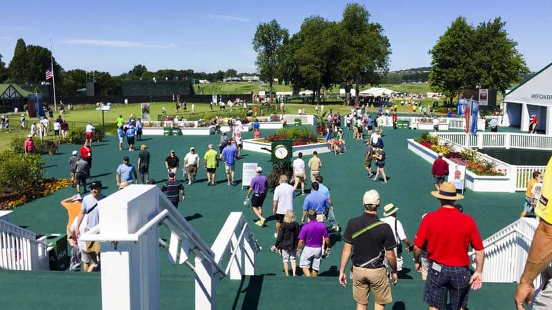 Folks file in to watch the practice rounds.