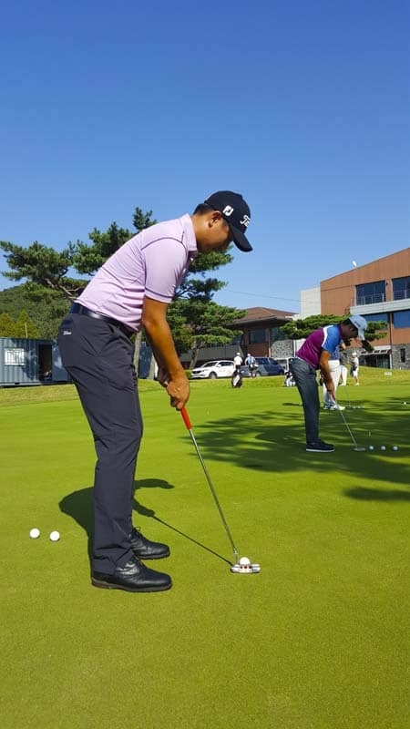 On the practice green with a Newport Tour putter.
