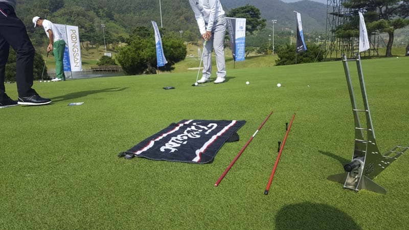 Drilling on the practice putting surface.