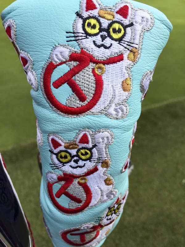 Scotty's version of maneki-neko, or "beckoning cat" with Circle Ts for good luck.